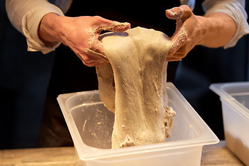 Image showing close up of baker hands making bread dough