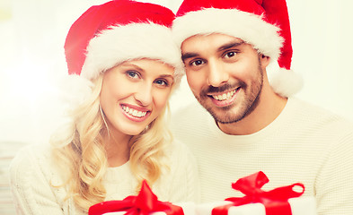 Image showing happy couple at home with christmas gift boxes