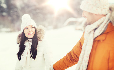 Image showing happy couple walking over winter background