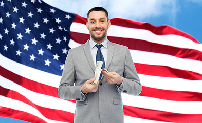 Image showing smiling businessman with american dollar money