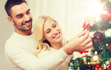 Image showing happy couple decorating christmas tree at home