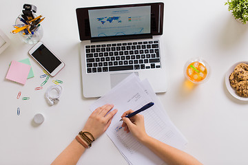 Image showing hands with papers and laptop at office table