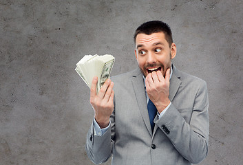 Image showing greedy businessman with american dollar money