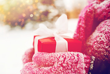 Image showing close up of woman holding christmas gift outdoors