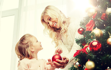 Image showing happy family decorating christmas tree at home