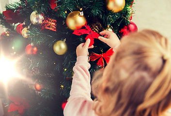 Image showing close up of child decorating christmas tree
