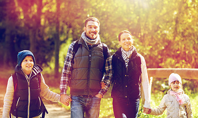 Image showing happy family with backpacks hiking