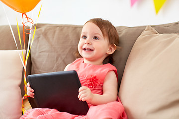 Image showing baby girl with tablet pc on birthday party at home