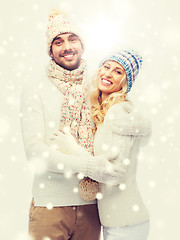 Image showing smiling couple in winter clothes hugging