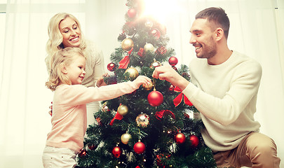 Image showing happy family decorating christmas tree at home