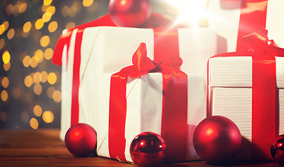 Image showing gift boxes and red balls on wooden floor