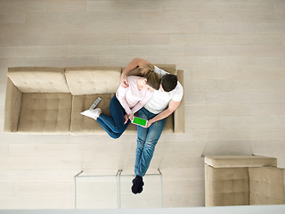 Image showing couple on sofa using tablet computer top view