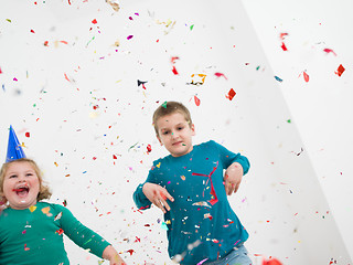 Image showing kids  blowing confetti