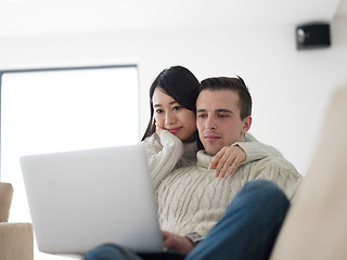 Image showing multiethnic couple using laptop computers