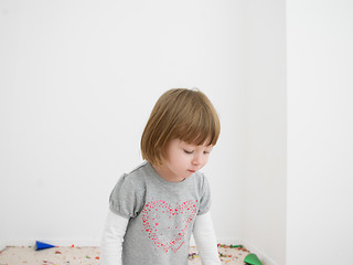 Image showing Little girl standing on confetti