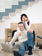 Image showing happy multiethnic couple relaxing at home