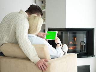 Image showing Couple using digital tablet on cold winter day