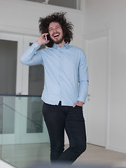 Image showing man using a mobile phone  at home