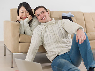 Image showing happy multiethnic couple relaxing at home