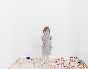 Image showing Little girl standing on confetti