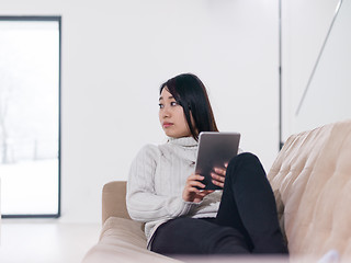 Image showing asian woman using Digital Tablet on sofa