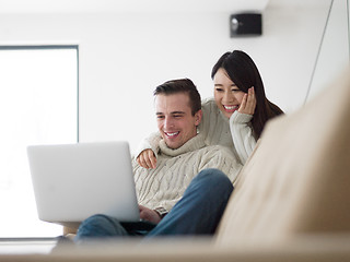 Image showing multiethnic couple using laptop computers