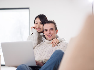 Image showing multiethnic couple using laptop computers