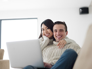 Image showing multiethnic couple using laptop computers