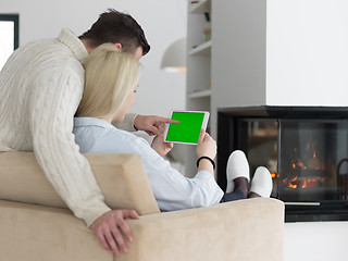 Image showing Couple using digital tablet on cold winter day