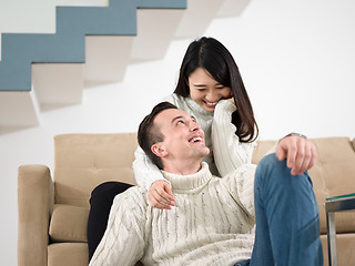 Image showing happy multiethnic couple relaxing at home