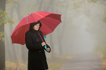 Image showing Woman with red umbrella 