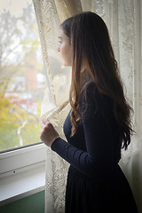 Image showing Young girl in black vintage dress 