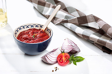 Image showing Bowl of chopped tomatoes on rustic table