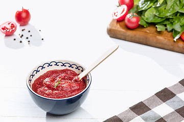 Image showing Bowl of chopped tomatoes on rustic table