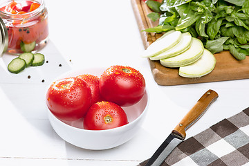 Image showing Canned tomatoes and fresh tomato on white background