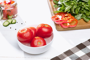 Image showing Canned tomatoes and fresh tomato on white background