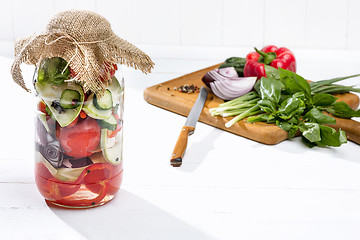 Image showing Canned tomatoes and fresh tomato on white background