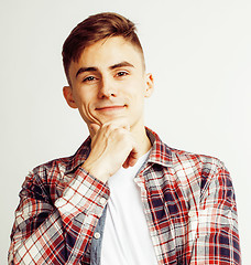 Image showing young handsome teenage hipster guy posing emotional, happy smiling against white background isolated, lifestyle people concept