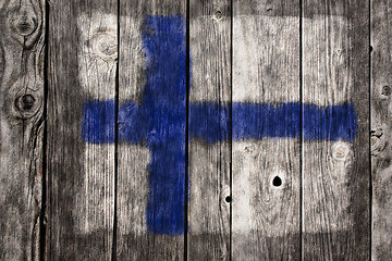 Image showing finnish flag on aged wooden wound