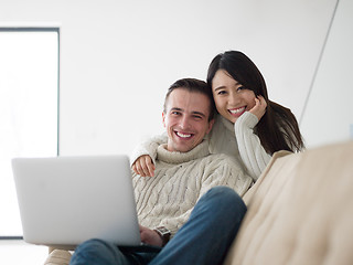 Image showing multiethnic couple using laptop computers