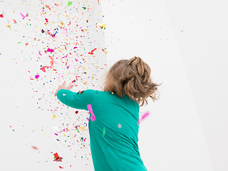 Image showing kid blowing confetti