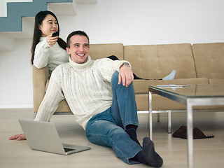 Image showing multiethnic couple on the sofa watching television