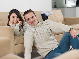 Image showing happy multiethnic couple relaxing at home