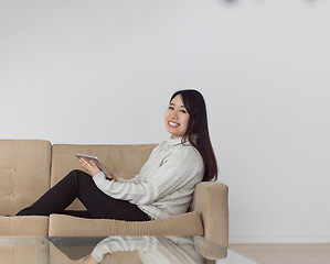 Image showing asian woman using Digital Tablet on sofa