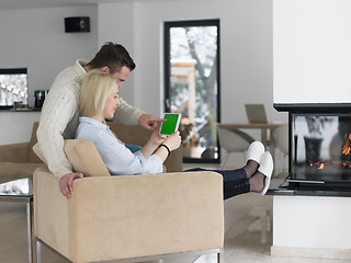 Image showing Couple using digital tablet on cold winter day