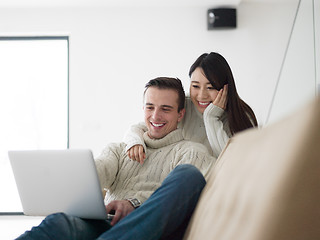Image showing multiethnic couple using laptop computers