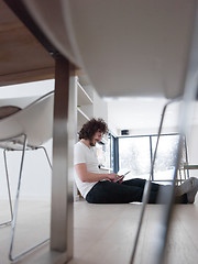 Image showing young man using a tablet at home