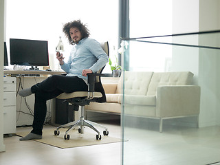 Image showing man using a mobile phone  at home