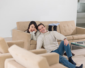 Image showing happy multiethnic couple relaxing at home