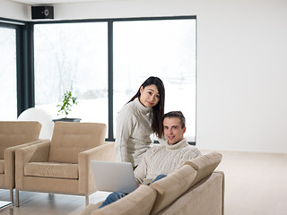 Image showing multiethnic couple using laptop computers